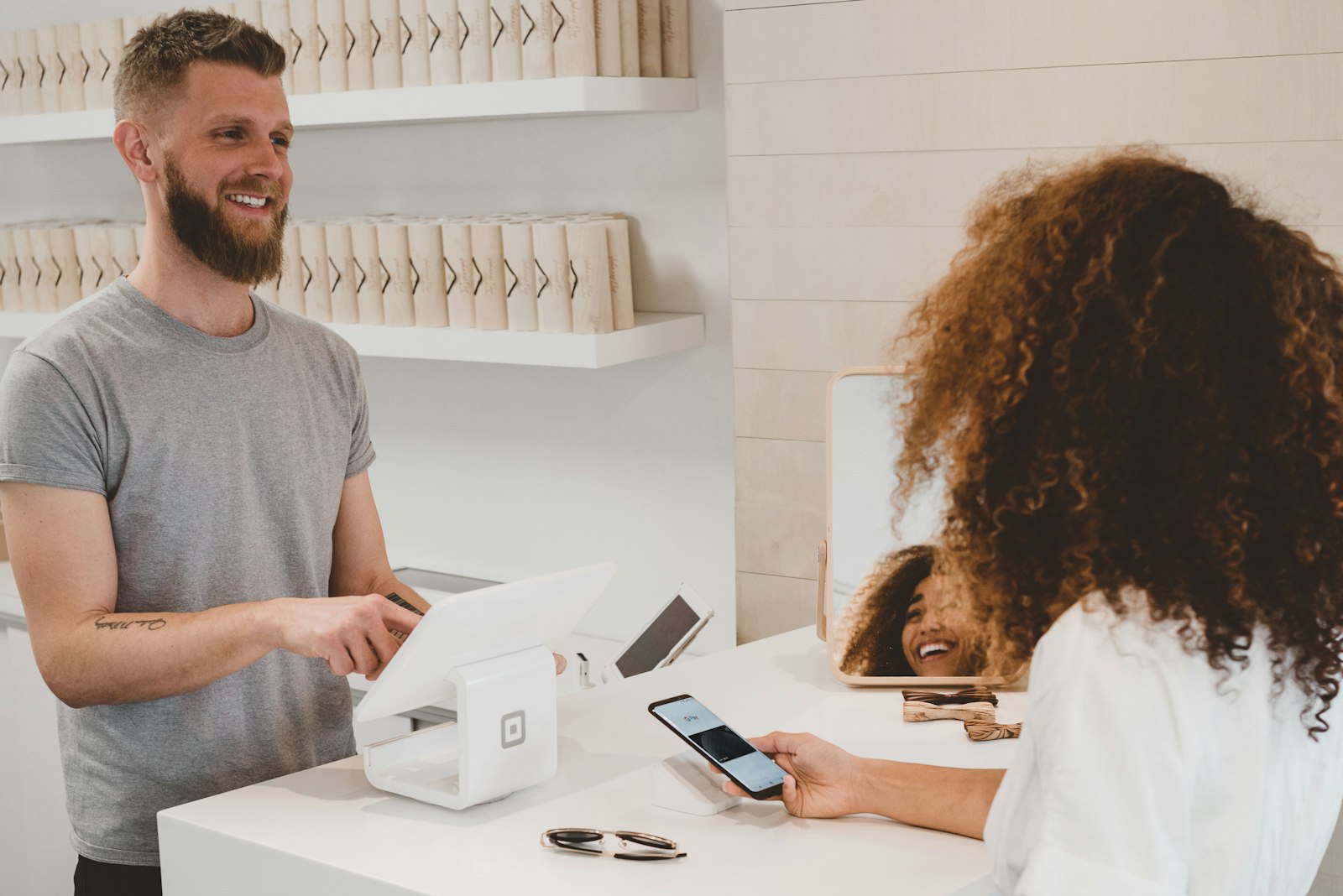 A customer tapping to pay at a counter